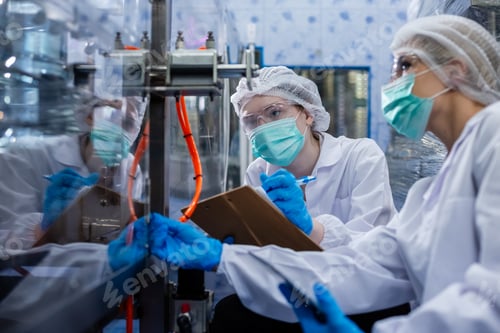 Preview: Female worker take note checking quality drinking water before process