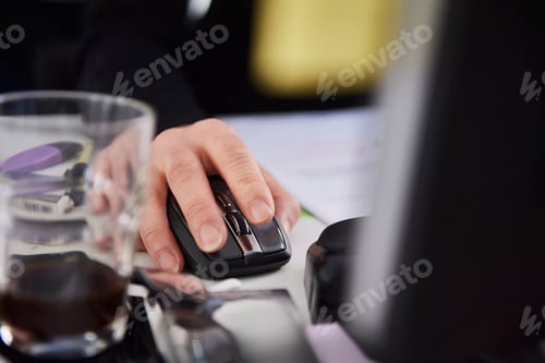 Preview: Cropped view of woman using computer mouse
