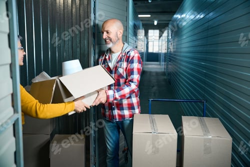 Preview: Adult guy passes things in a box to a woman