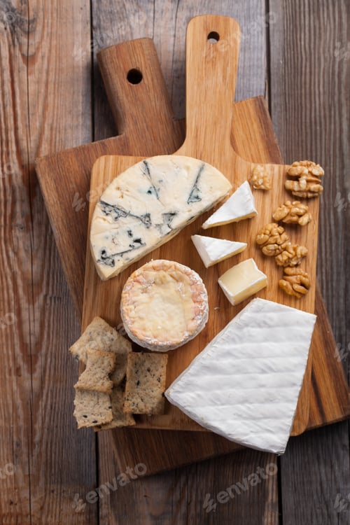 Preview: Tasting cheese dish on a wooden plate. Food for wine and romantic, cheese delicatessen