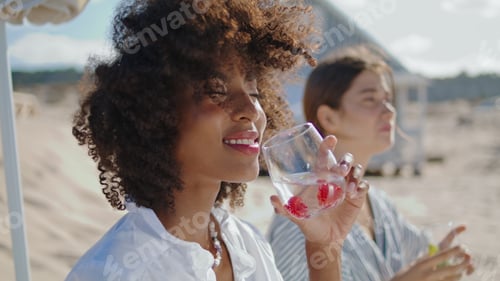 Preview: Beautiful woman enjoying cocktail closeup. Happy african american drinking soda