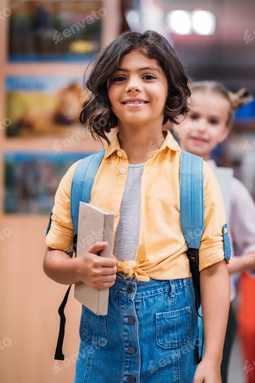 Preview: beautiful little schoolgirls in school library
