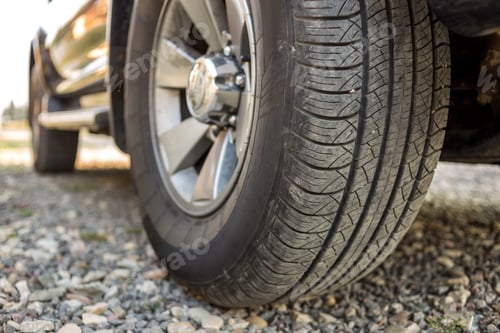 Preview: Close-up detail of car wheel with aluminum disc and black rubber tire protector