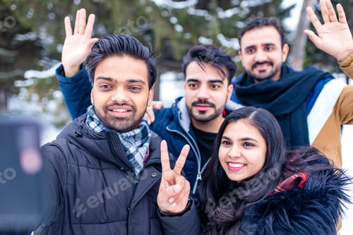 Preview: arabic guys having great time on Christmas holidays taking selfie photo on phone