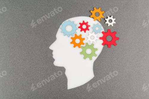 Preview: top view of cut out white human head with colorful gears isolated on grey