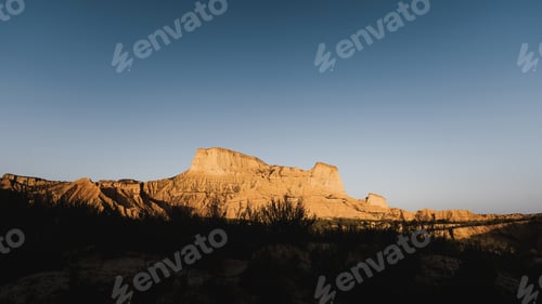 Preview: Warm sunlight illuminating majestic rock formations in bardenas reales, navarra, spain