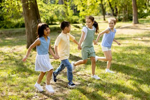 Preview: Group of asian and caucasian kids having fun in the park