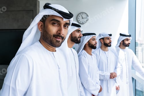 Preview: Arab businessmen wearing emirati kandura meeting in office for business deal