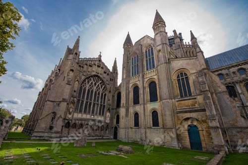 Preview: Ely Cathedral with gothic style surrounded by trees in the daytime in Chapter House, The College, UK