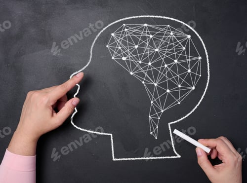 Preview: A woman's hand draws a silhouette of the head and connections inside the brain. Learning concept
