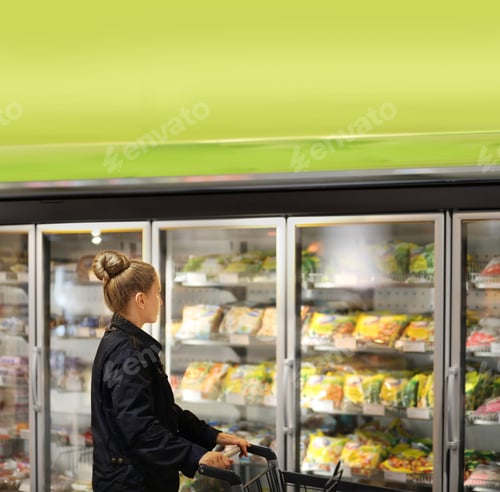 Preview: Woman Choosing Frozen Food From A Supermarket Freezer