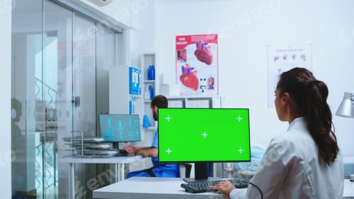 Preview: Doctor typing on computer with copy space