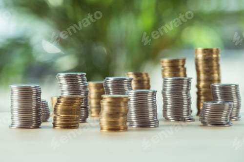 Preview: selective focus of different stacks of coins standing on table