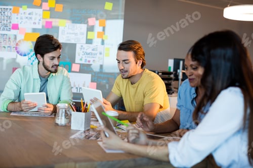 Preview: Creative business team working together on desk