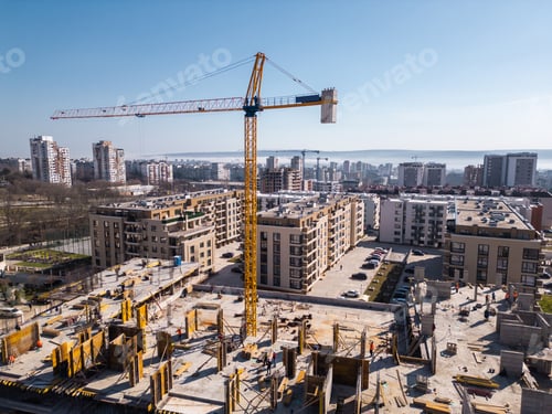 Preview: Aerial view of a cityscape with ongoing construction projects and completed residential buildings