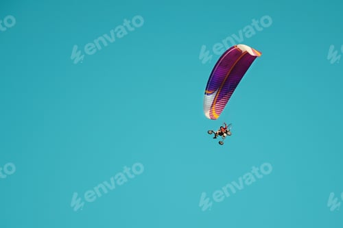 Preview: Paraglider flies with a parachute on an air motorcycle a propeller. Paragliding