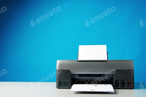 Preview: Laser printer on desk against blue background.