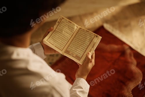 Preview: Close up of Muslim reading from Quran.