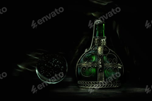 Preview: Glass green bottle with magic potion on a dark background. Magic elixir.