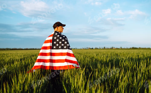 Preview: Man hold waving american USA flag. Patriot raise national american flag. Independence Day, 4th July.