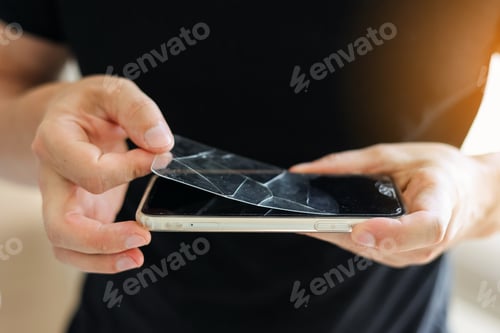 Preview: Process unrecognisable repairman is removing broken and old tempered glass screen protector from