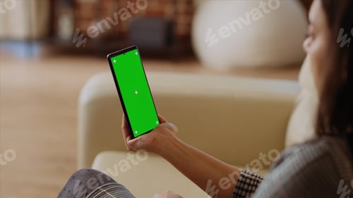 Preview: Woman using green screen smartphone gyroscope function while at home