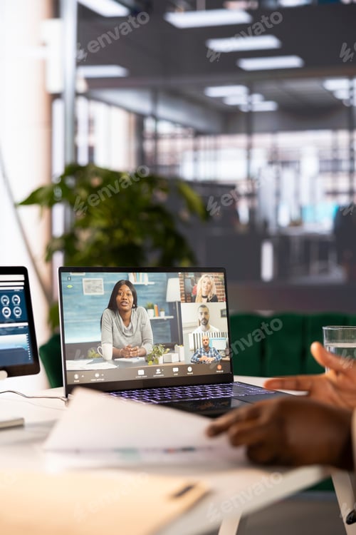 Preview: Close up of CEO in startup office holding videocall meeting with remote workers
