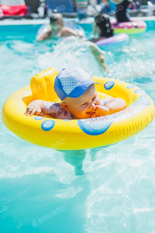 Preview: A one-year-old little boy swims in an inflatable circle in the pool. Children's pool.