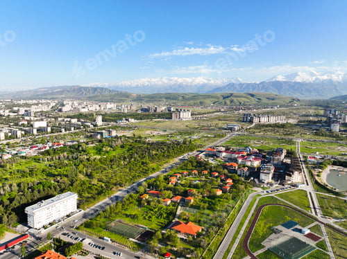 Preview: Residential area and park with snowcapped mountain backdrop