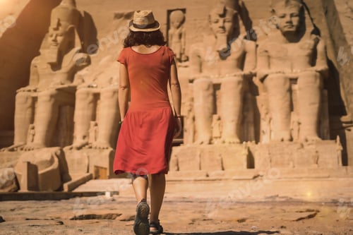 Preview: A young tourist in a red dress entering the Abu Simbel Temple in southern Egypt