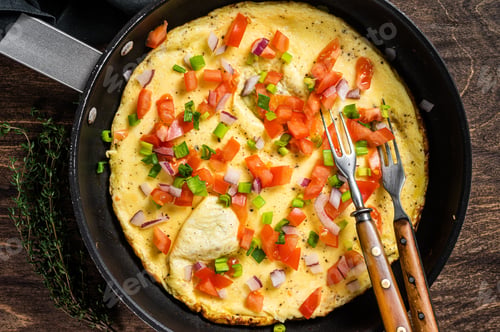 Aperçu: Healthy breakfast food, Stuffed egg omelet with vegetables in a skelet. Wooden background. Top view