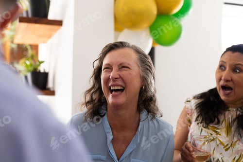 Preview: Laughing joyfully, senior woman at lively celebration with friends outdoors