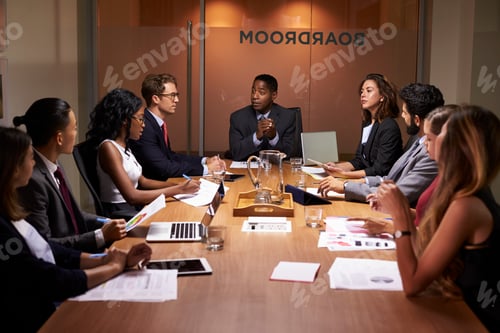 Preview: Corporate business people at an evening boardroom meeting