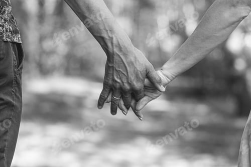 Preview: The husband's flour holds his wife's hand tightly in close-up.