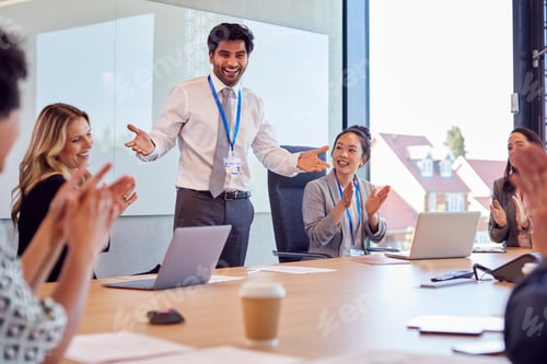 Preview: Businessman Leading Multi-Cultural Business Team Meeting And Collaborating Around Table In Office