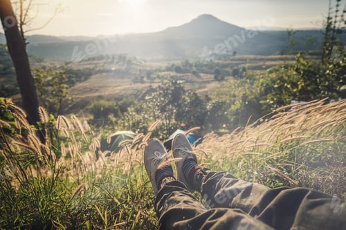 Preview: Traveler sitting and looking at view of nature