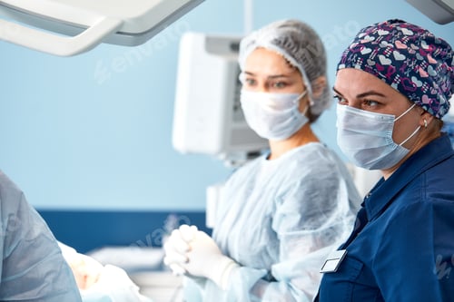 Preview: Concentrated Surgical team operating a patient in an operation theater