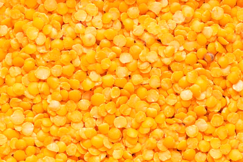 Pile of Vibrant Yellow Lentils on a Table