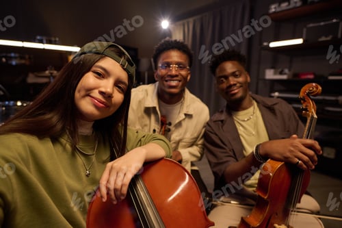 Preview: Portrait of Young Multiethnic Musicians Smiling While Holding String Instruments
