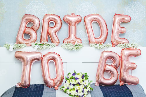 Preview: Bride to be balloon letters sign on the bed - bridal shower concept