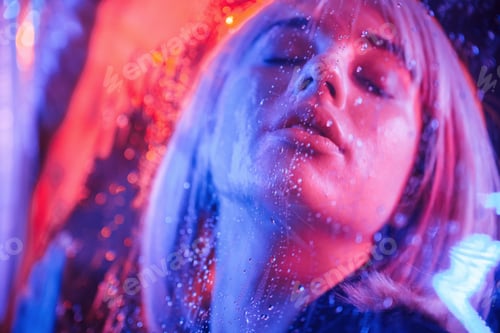 Preview: Eyes are closed. Stylish woman with white hair is behind wet transparent plastic sheet