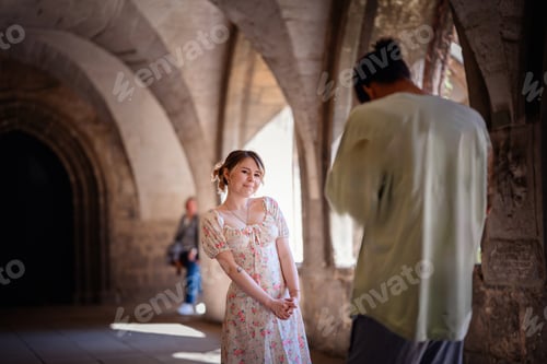 Preview: Photographer Capturing Woman in Historic Stone Corridor