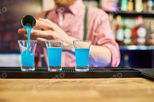 Preview: Bartender Pouring Vodka Shots at Bar Counter