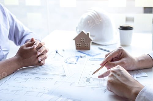 Preview: Construction engineering or architect discuss a blueprint while checking information on drawing and