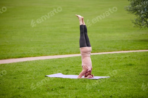 Preview: Her mind and body are in sync. Shot of a woman doing yoga in the park.