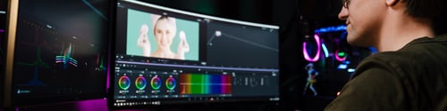 Preview: Back view of a young white man video editor