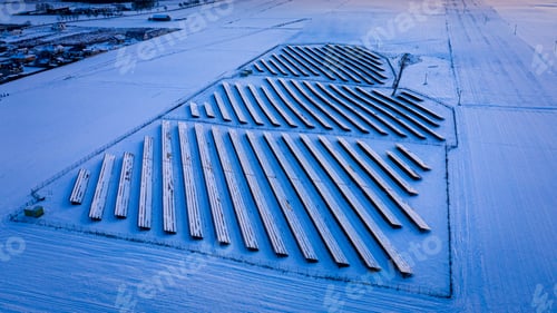 Preview: Alternative energy. Snowy solar panels. Frozen photovoltaic farm in winter.