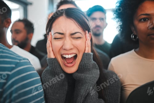 Preview: Shot of a young woman experiencing mental illness while being surrounded by people inside
