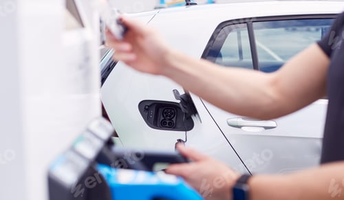 Preview: Man Charging Electric Vehicle Paying For Energy With Credit Card At Charging Station