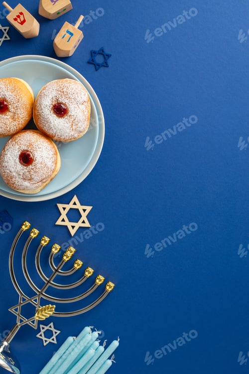 Preview: Stylish Hanukkah table arrangement. Top view vertical image of traditional Jewish meal - sufganiyot